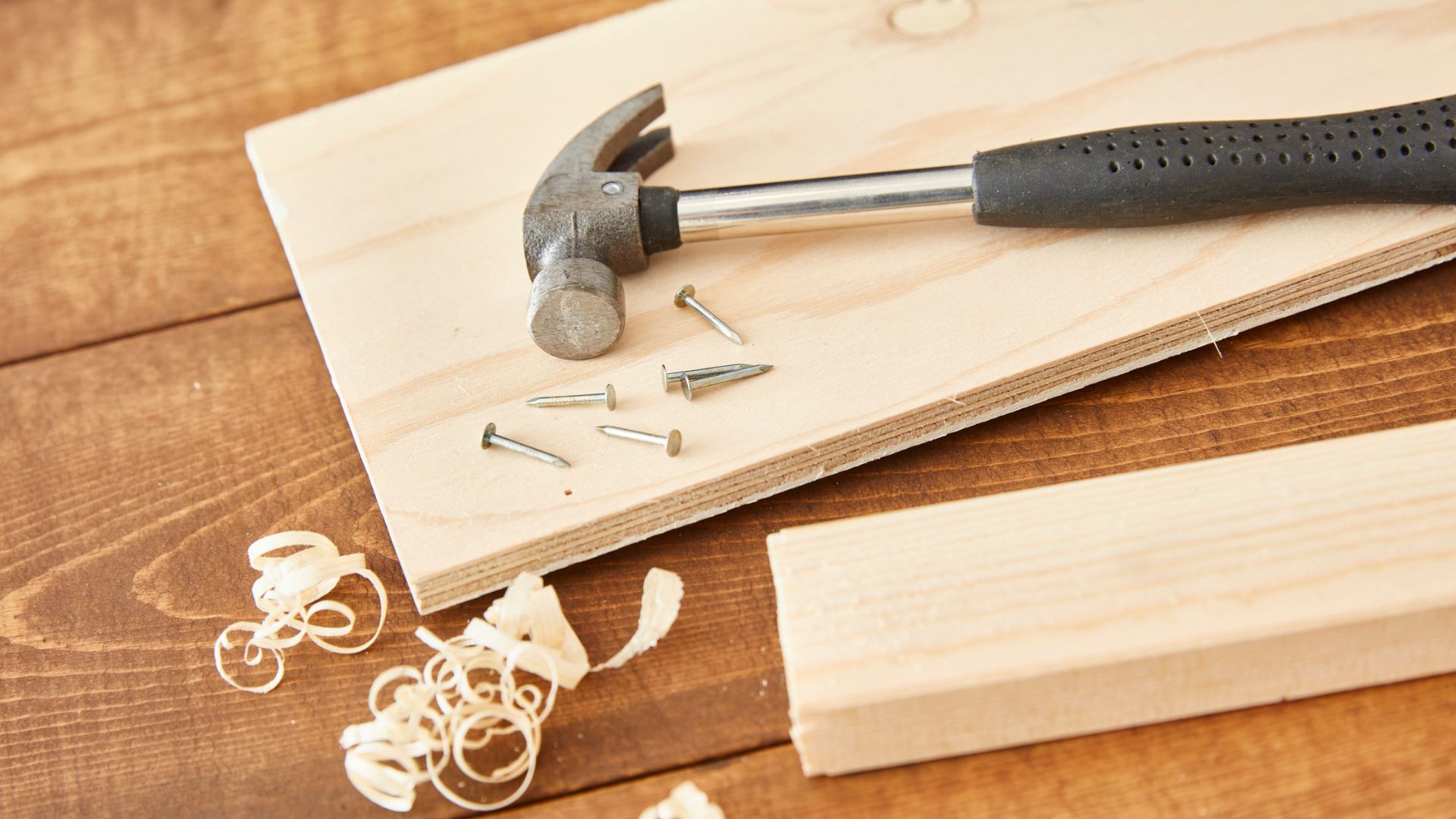 Website%20Dev.%20-%202025-07-02T154109.102 silver hammer lying on a wooden board